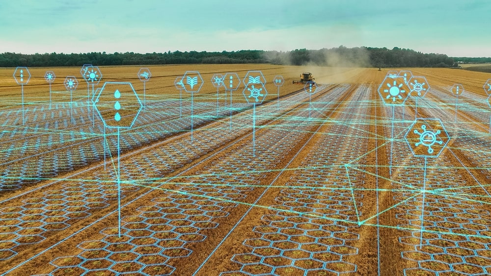 Aerial View: Harvester operating in the field, showcasing efficient crop scanning through AI data analysis icons.